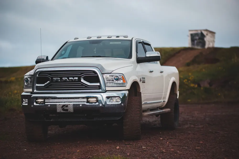 A white Ram heavy-duty truck parked on a dirt lot